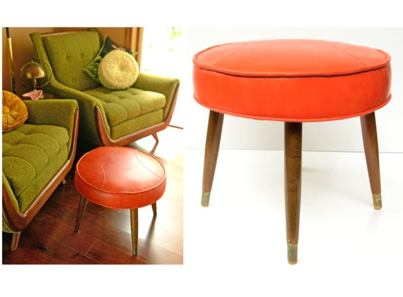 mid century ottoman,stool,vinyl,stool,orange,retro,atomic,round,side table,tapered wood legs,brass fittings,half moon stitching