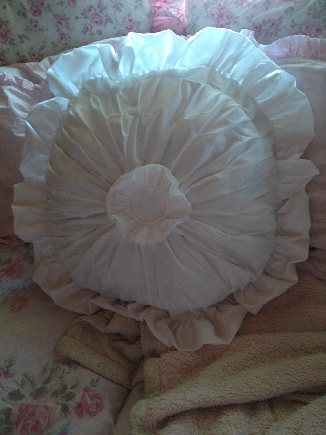 white round ruffled pillow
