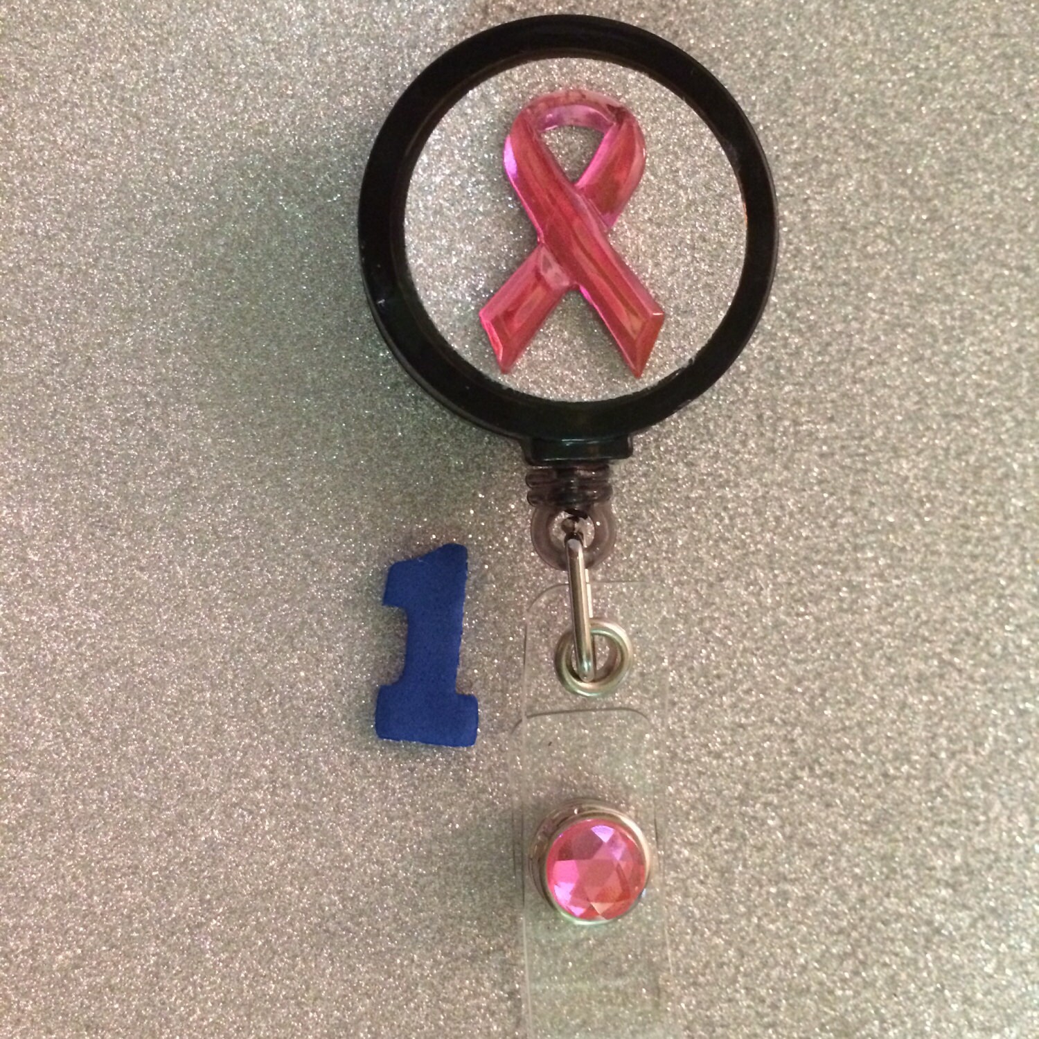 Glitter pink breast cancer ribbon on glitter bling background