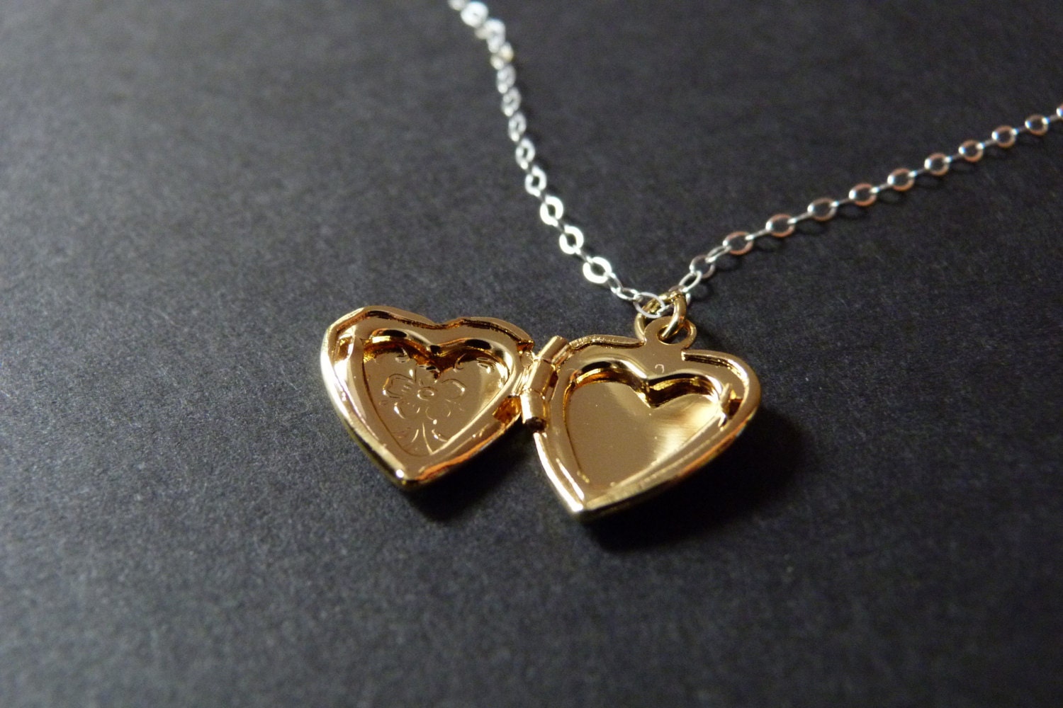 Gold heart locket necklace personalized with initial inside