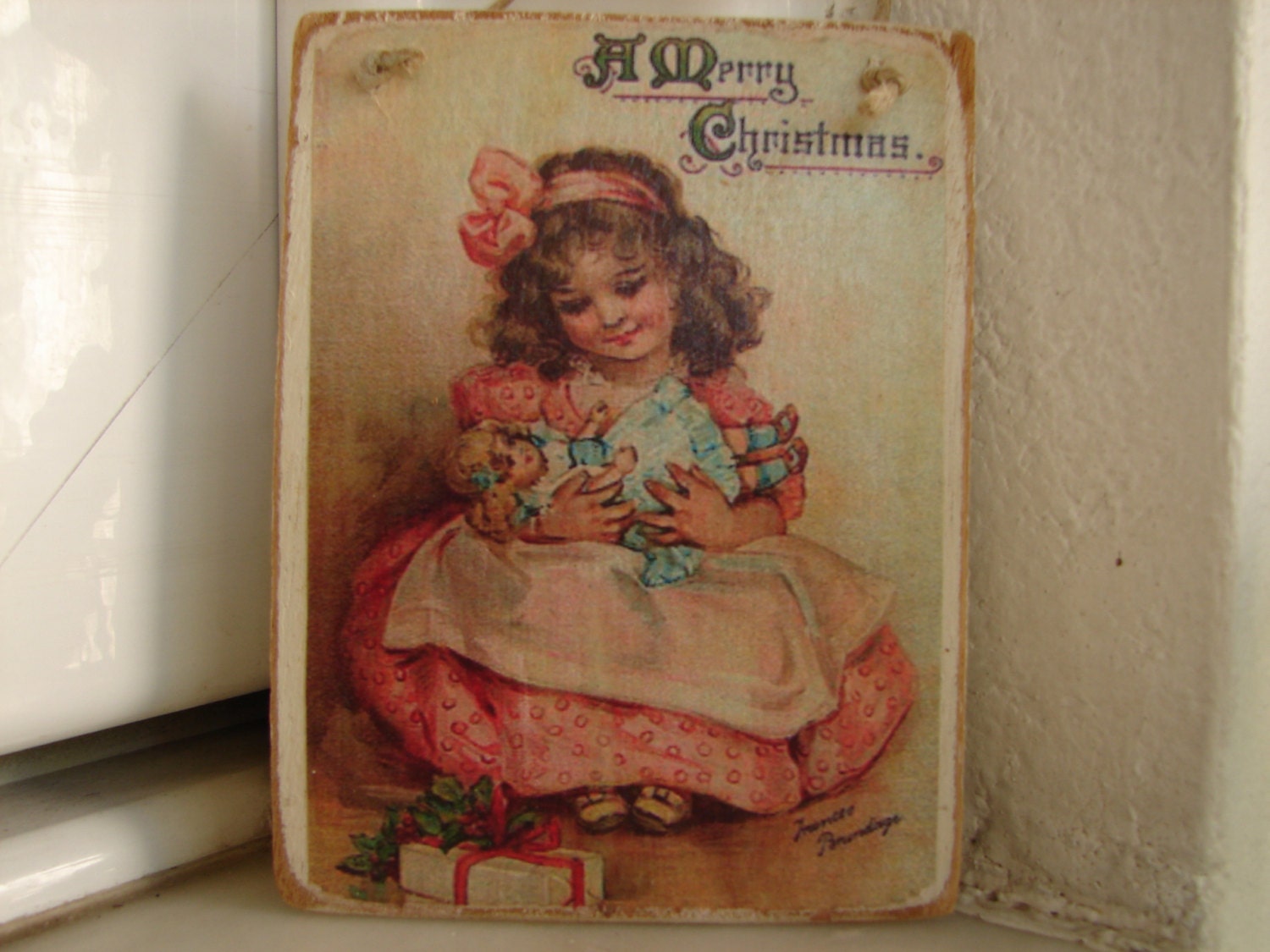 Victorian Christmas greeting,little girl with dolly,wooden tree or door decoration