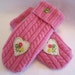 Women's bright pink cable knit woolen mittens with appliqued heart