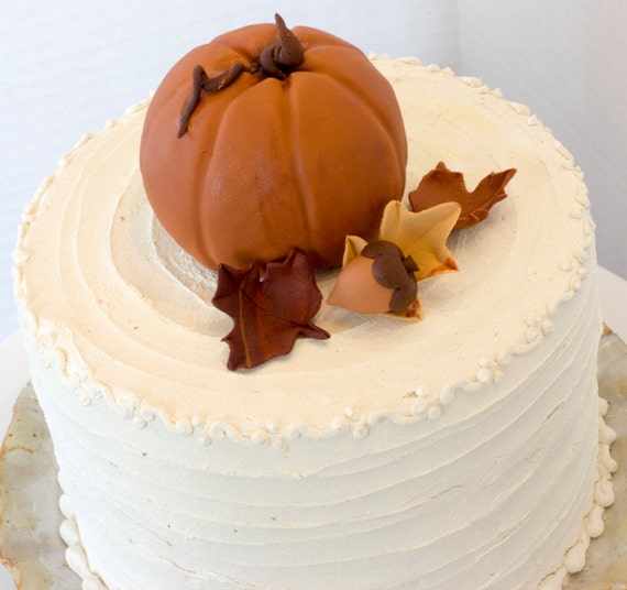 Fondant pumpkin cake topper with 3 leaves and acorn See