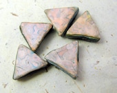 Triangular mokume gane strata beads in polymer showing pink and turquoise distressed pattern