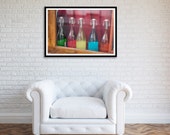 Fine art print of colorful class bottles displayed in a shop window in Paris France.