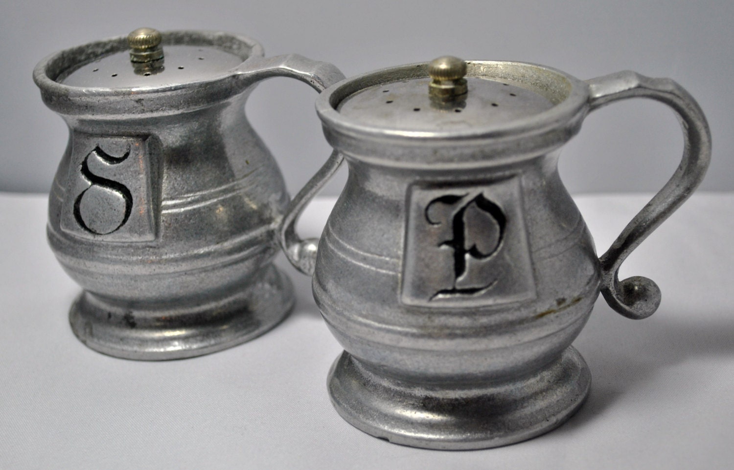 Vintage set of pewter salt and pepper shakers.