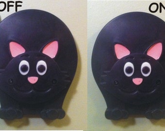 Black cat light switch cover with switching tail