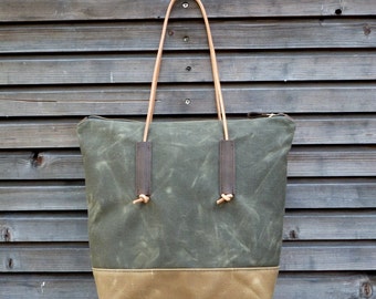 Waxed canvas tote bag with leather handles and zipper closure