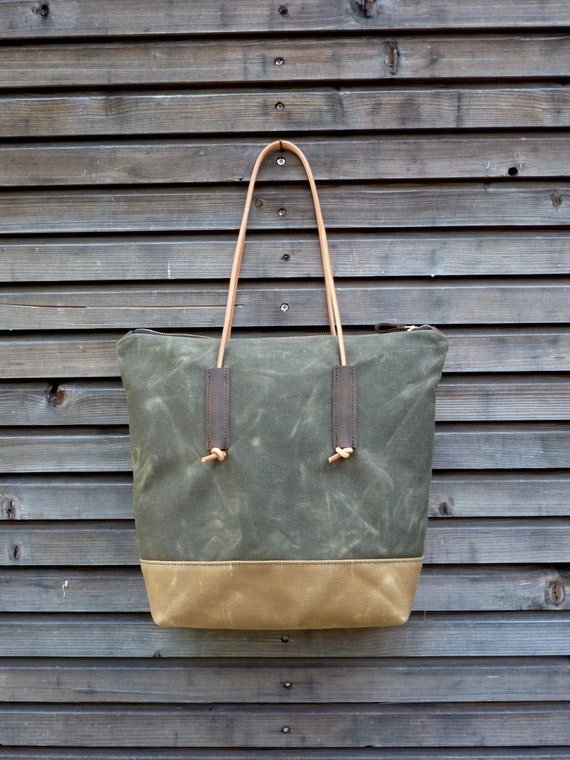 Waxed canvas tote bag with leather handles and zipper closure