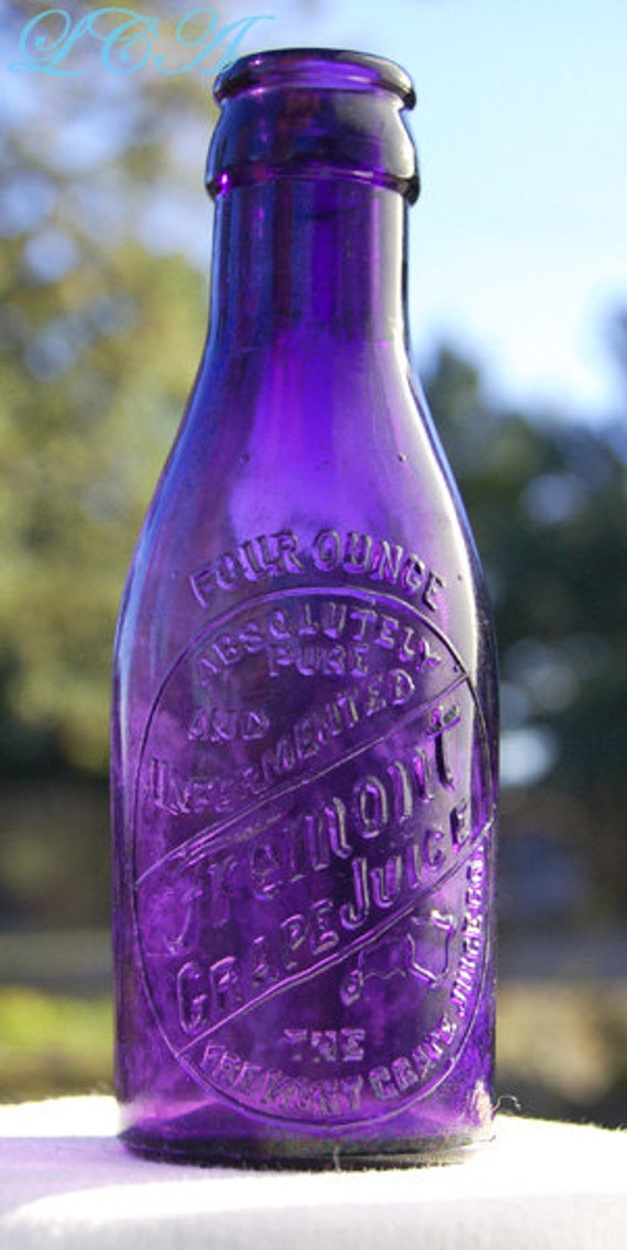 Small antique FREMONT Ohio GRAPE JUICE bottle in a vibrant