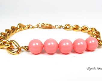 Pink coral and gold arm candy. Swarovski crystals pink coral and gold bracelet