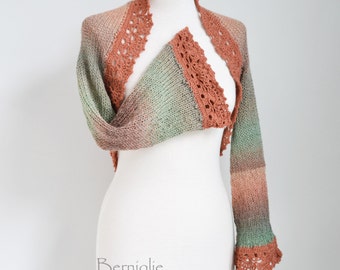 Knitted shrug in peach and soft green with lace crochet trims K47