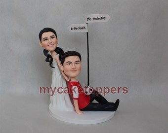 wedding cake toppers dragging groom