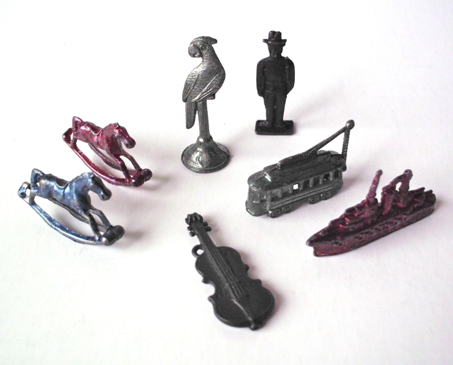 Set of Seven Vintage Cracker Jack Metal Toys Parrot Trolley