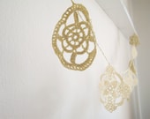 Golden crochet garland in vintage style. Winter home decor.