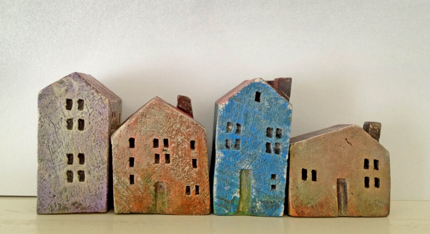 set of 4 ceramic houses in a row made in high fired