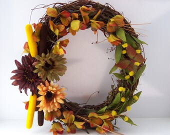 Outdoor indoor grapevine artificial autumn flower wreath with cattails.