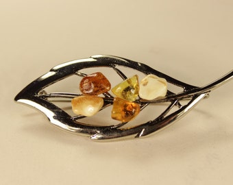 Chrome brooch with natural Baltic amber