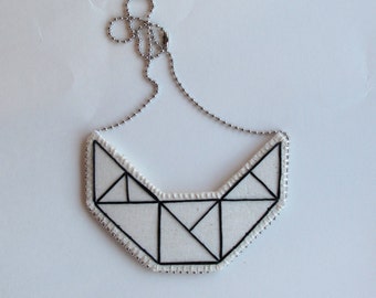 Small embroidered geometric bib necklace on cream muslin with black outline Winter fashion