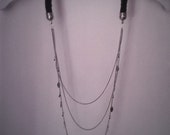 Chain and spool knitted necklace. Black i-cord and silver chain with black seed beads and  metal leaves decorations.