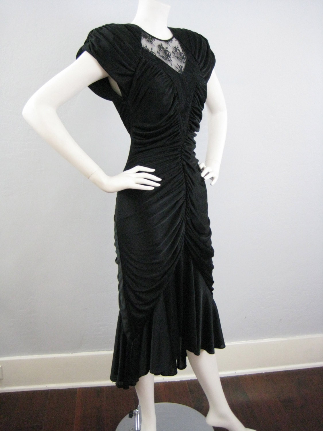 black dress with shoulder pads