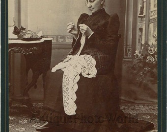 Woman crocheting lace antique art cabinet photo