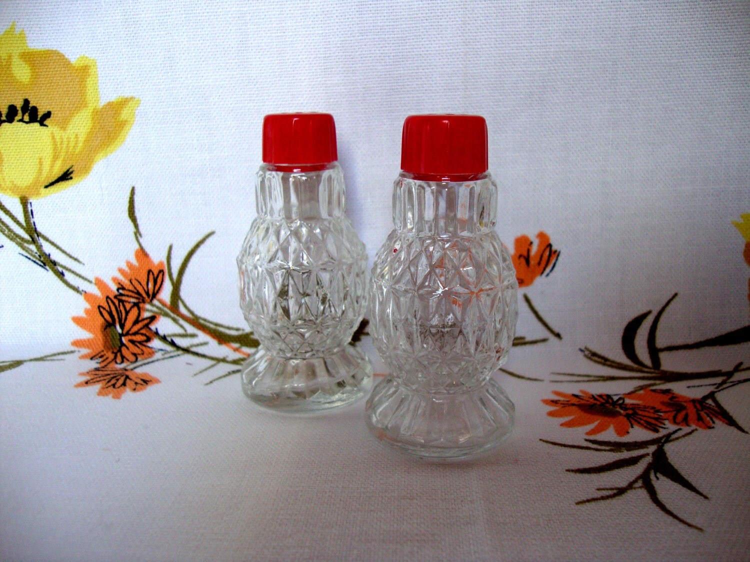 Pressed glass salt and pepper red plastic lids Haute Juice
