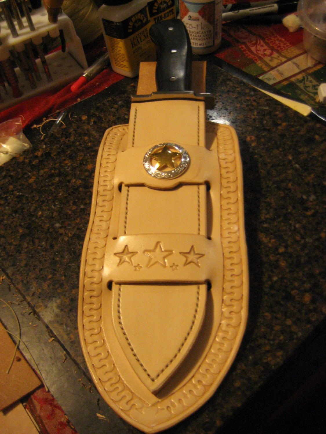 Frontier cowboy style leather knife sheath with bowie knife