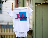 Baby bodysuit featuring any desired name in an actual photo of a full sign (if available)