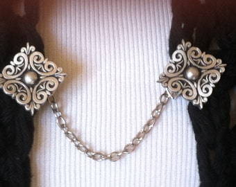 The mattie pewter Celtic square sweater clip adds a touch of interest to your cover ups.