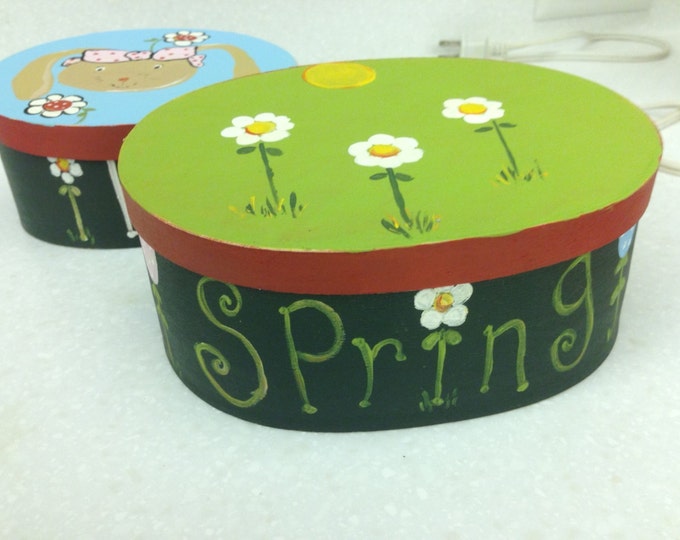 Two wood nesting boxes decorated for spring - "I Love" on one and "Spring" on the other