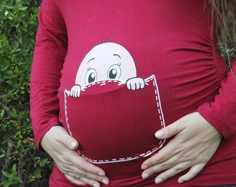 baby peeking out of belly shirt