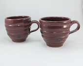 pair of red and blue spotted mugs