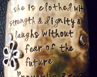Hand Stamped Leather cuff bracelet...silver flower on beautiful brass plate...She is clothed dignity and strength.. scripture bracelet
