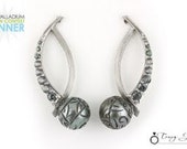 Tahitian carved pearl and color change garnet earrings set in palladium.