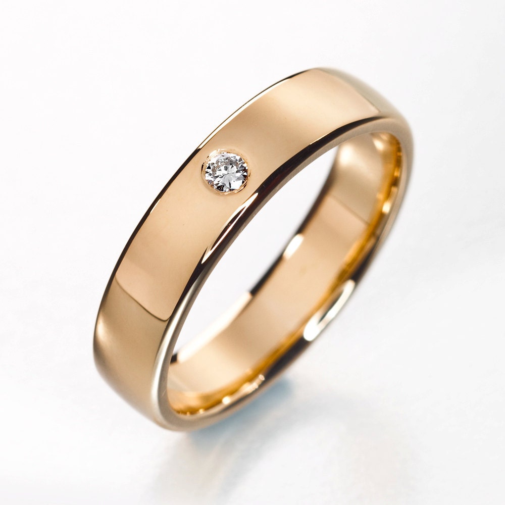 ring with two simple wedding bands and a solitaire in between