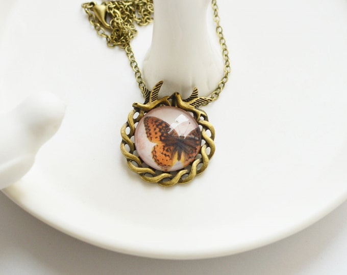 IN THE FOREST Round necklace of metal brass with depiction of butterflies under glass