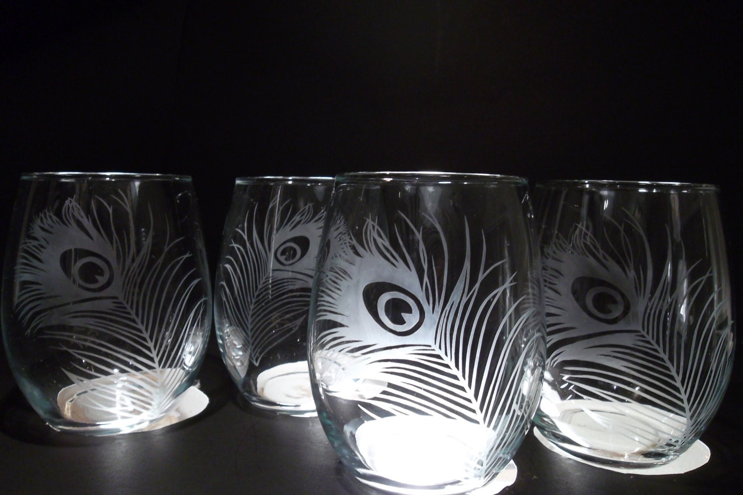 Stemless etched wine glasses. Peacock feathers bridesmaids