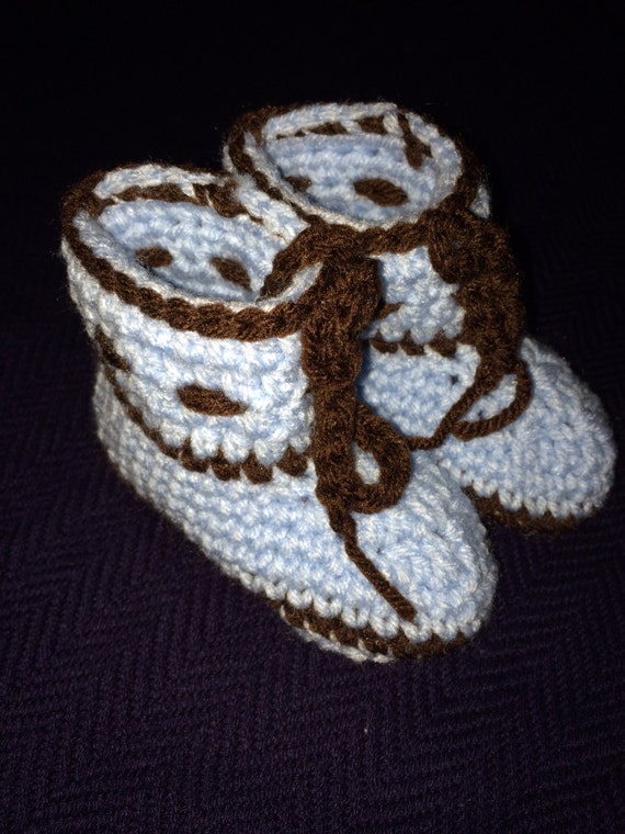 Crochet baby booties for baby boy or baby girl.