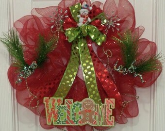 REDUCED PRICE! Christmas wreath made with red deco mesh ribbon accented with green and red bow featuring a cute snowman