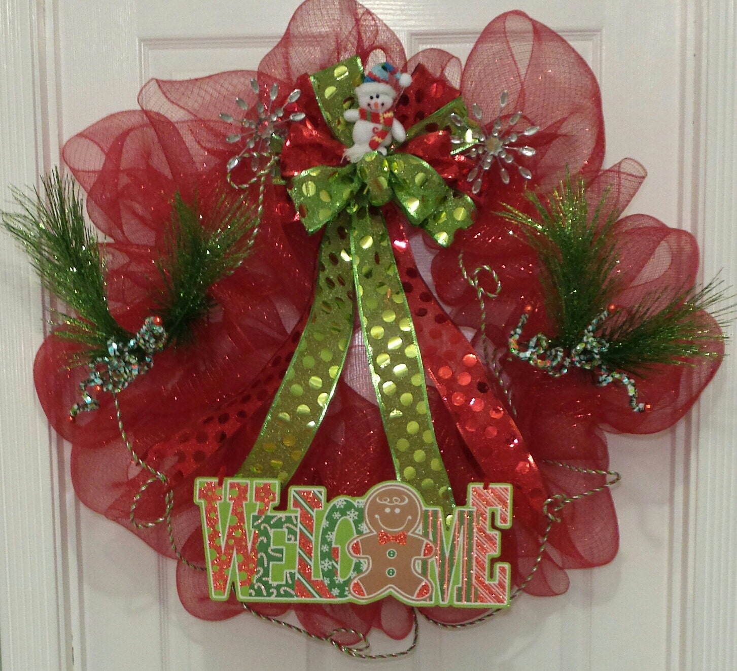 REDUCED PRICE! Christmas wreath made with red deco mesh ribbon accented with green and red bow featuring a cute snowman