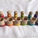 Montessori inspired matching game with peg dolls and cups