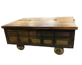 Antique Rustic Chest on wheels COFFEE TABLE Hand carved Eclectic UNique brass and iron front