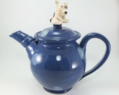 blue teapot with a dog