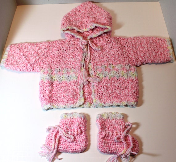 Crochet baby sweater with hood and matching booties.