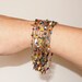 Multi Strand beaded Bracelet - Vintage multi color Beads - Gold tone filigree clasp - Red, orange, black, blue, white and green beads
