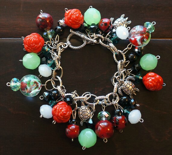 Red and green assorted glass bead charm bracelet and matching