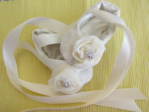 Ivory colored satin and lace baby ballerina style shoes.