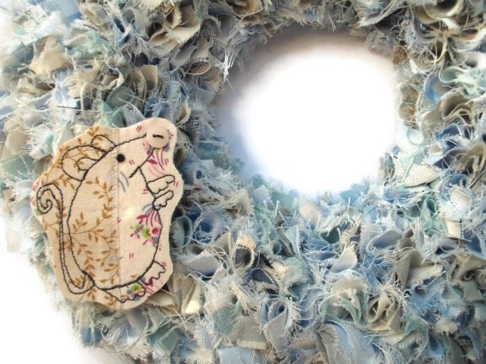 blue cotton wreath embellished with a handmade mouse brooch