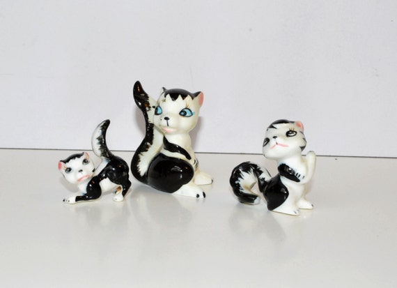 ceramic skunk figurines